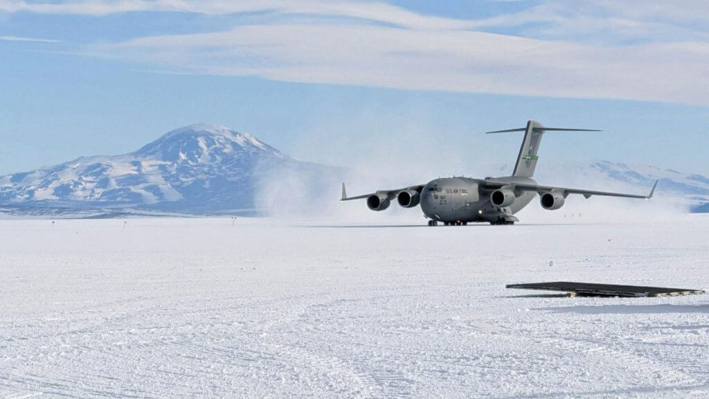 An image showing a U.S. Air Force C-17 cargo plane, landing on a permanent ice runway