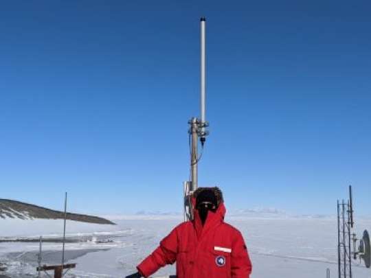 An image of Swarm Co-Founder and CTO, Dr. Benjamin Longmier, on top of the Comms Building in McMurdo Station
